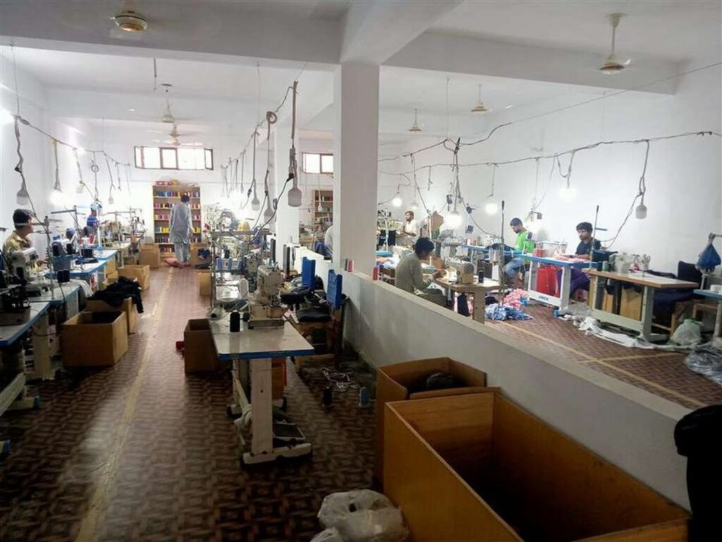 Greyfin Sports apparel production floor with industrial sewing equipment