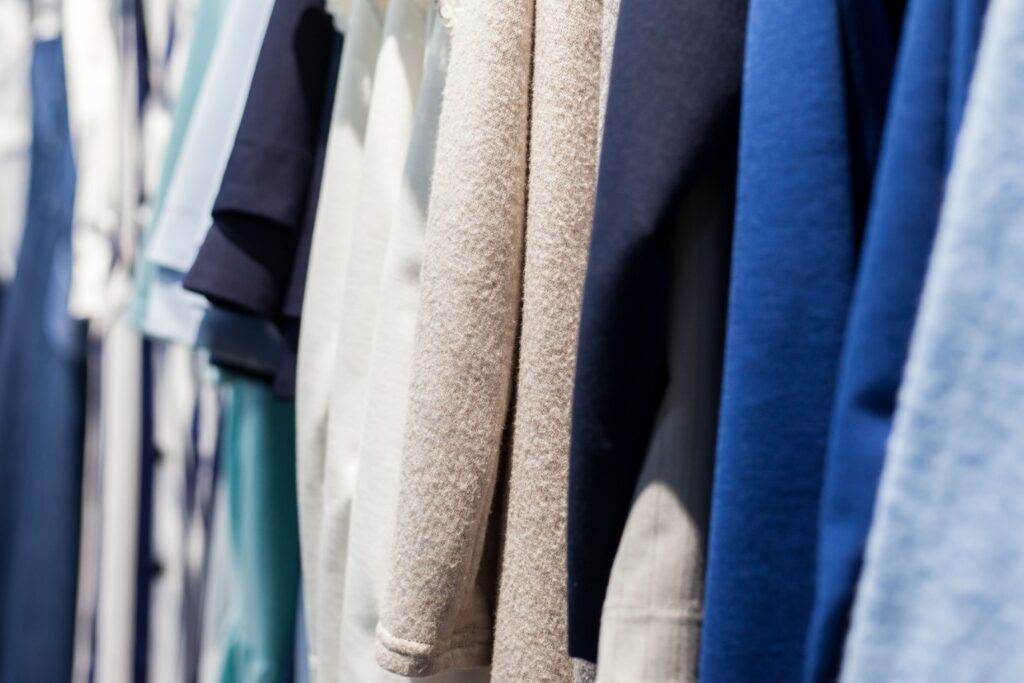 Close-up of hanging garments showing fabric textures and surface finishes