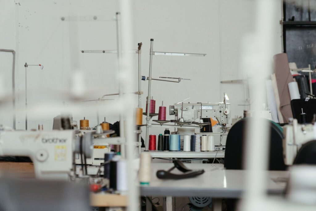 Industrial sewing machines and thread cones in a garment workspace